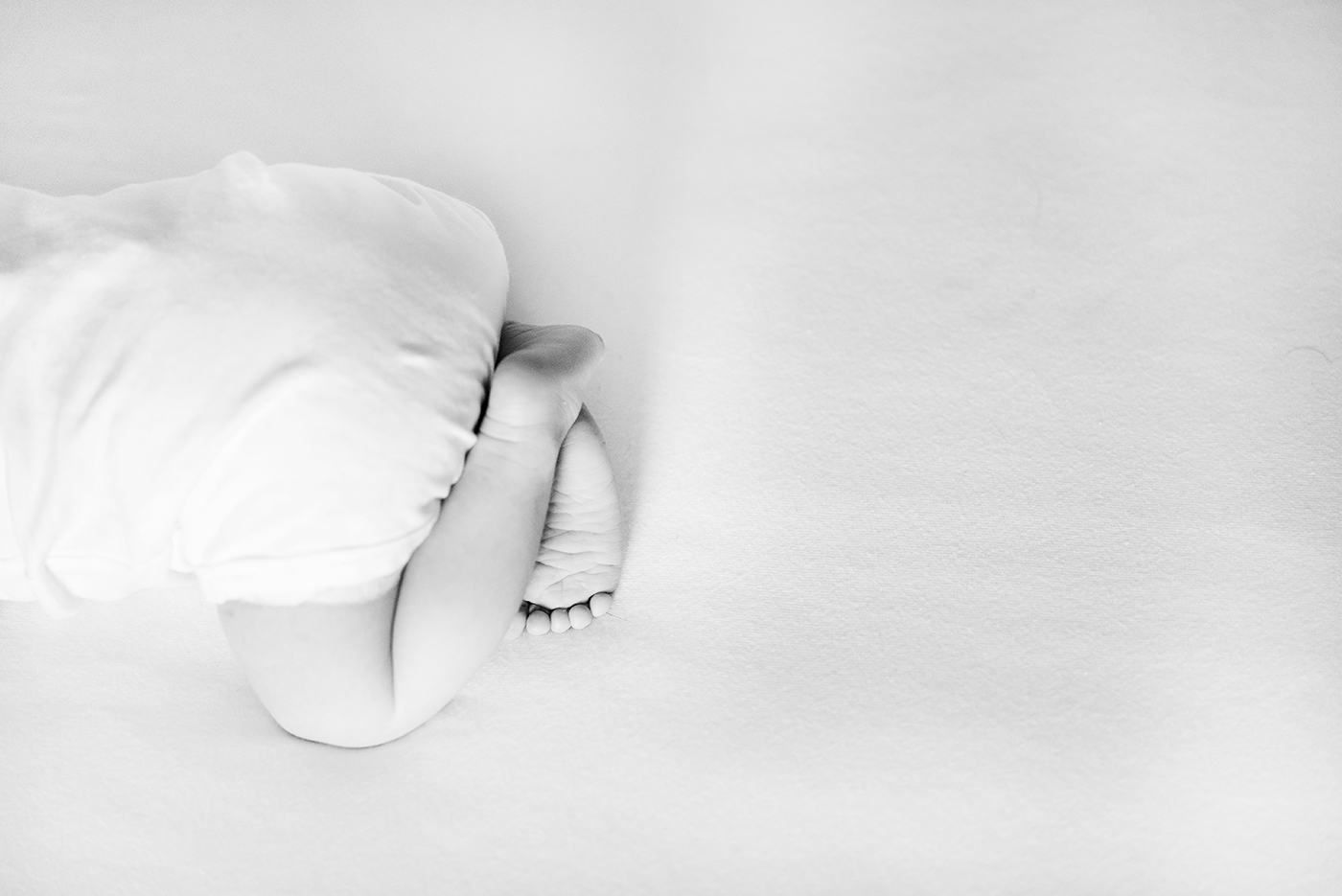 Light black-and-white photo of baby feet