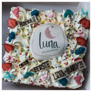 Taart met het Luna-logo en de tekst Hoera! Onze eerste Luna-baby!!