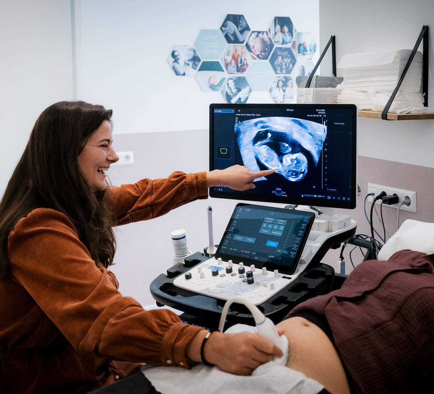 Echoscopiste wijst de baby aan op het scherm van het echoapparaat